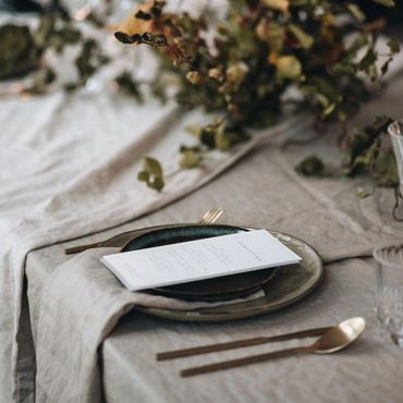 Elegant table setting with dried foliage and minimalist tableware.