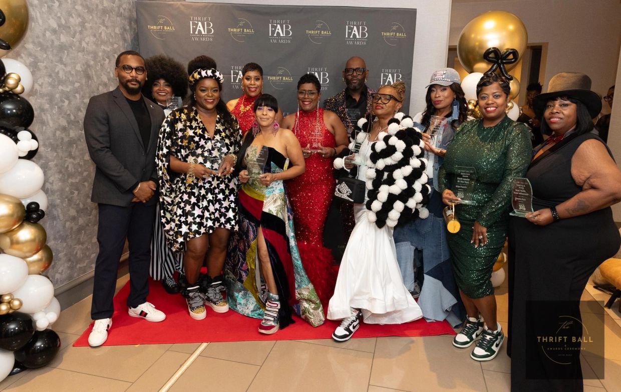 Group photo at The Thrift Ball awards with diverse fashion styles.