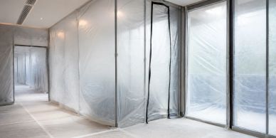 Interior space sealed with plastic sheeting for renovation or containment.