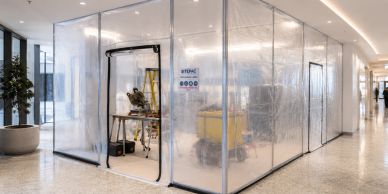 Temporary plastic enclosure for construction work in a building corridor.
