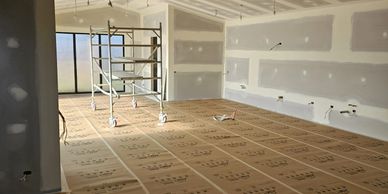 Room under construction with drywall and scaffolding.