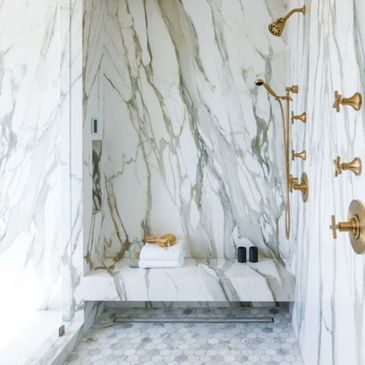 calacatta gold porcelain slab bathroom with slab bench and slab seat with hexagon mosaic floor