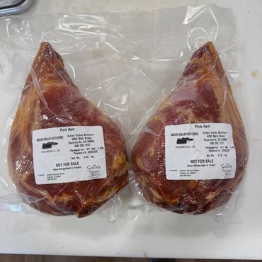 Two vacuum-sealed pork ham packages labeled 'Not For Sale' from Rojas Valley Butchers.
