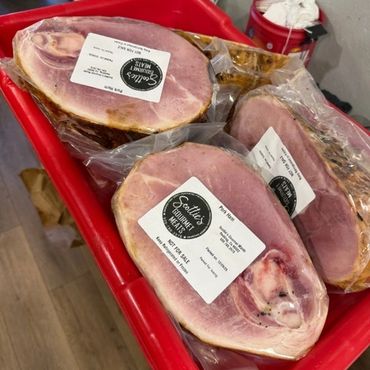 Vacuum-sealed ham pieces in a red plastic container.