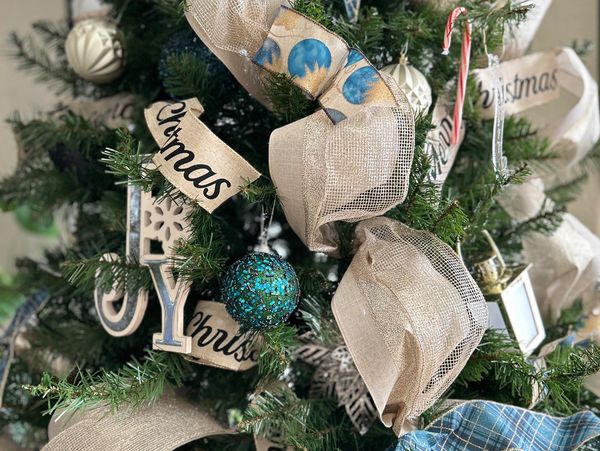 Christmas tree decorated with ribbons, ornaments, and candy canes.