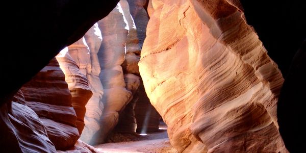 beam of light cascading into slot canyon