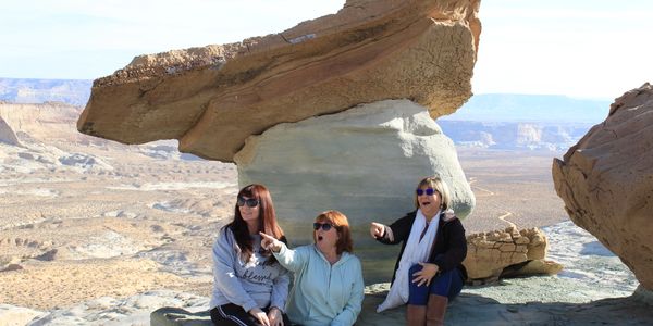 Group of women sitting below a hoodoo just outside of Page, Lake Powell, Arizona