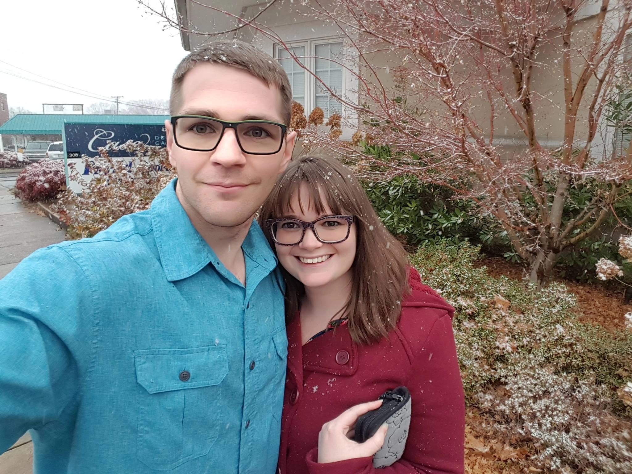 couple wearing glasses on a snowy day