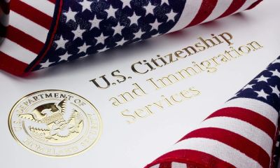 U.S. Citizenship and Immigration Services document with American flags.