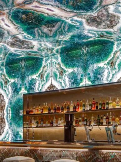 Backlit coastal style glass slab on walls and ceiling