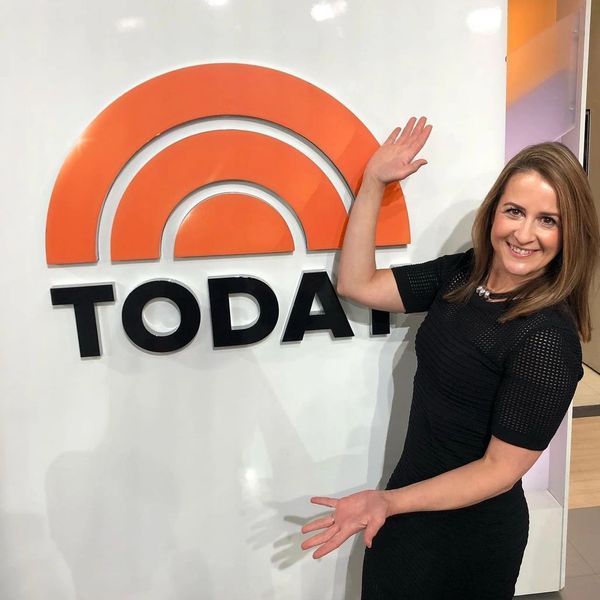 Woman standing in front of a sign that says TODAY