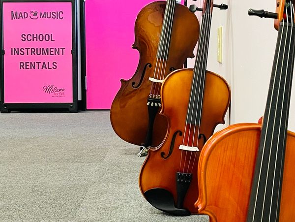 A violin, viola, and cello for rent at Mad Music.