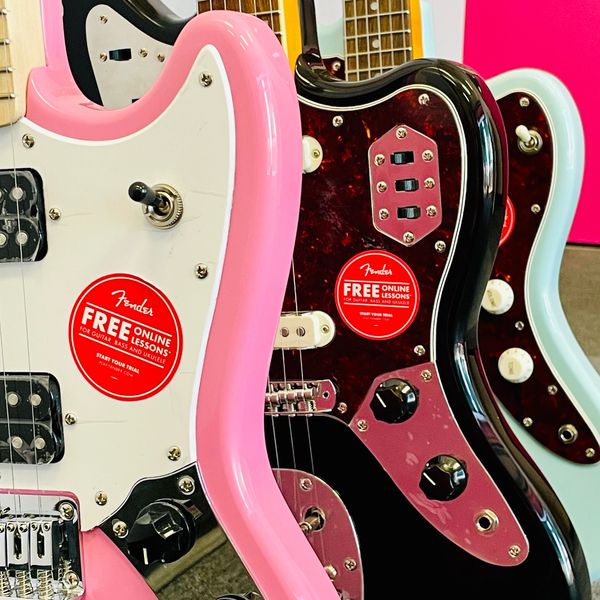 Squier by Fender electric guitars on display. From left to right: Mustang, Jaguar, and Jazzmaster.