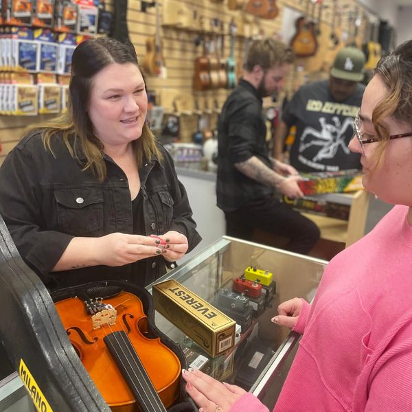 A customer renting a viola for orchestra in school.