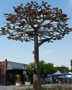Metal sculpture tree with red, yellow and green leaves