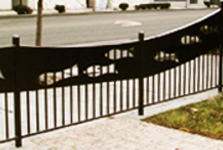 Wrought iron fence with negative space fish silhouettes swimming upstream