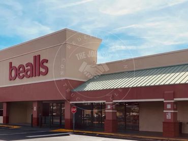 Exterior view of a Bealls retail store under a partly cloudy sky.