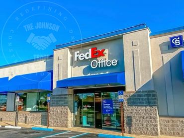 FedEx Office storefront with bright blue awnings on a sunny day.