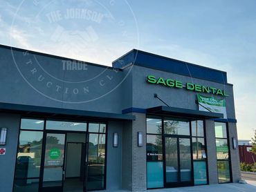 Exterior of a modern Sage Dental clinic with clear signage and parking spaces.