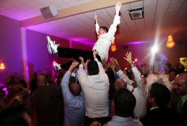 A group of people having fun at a after party of a wedding