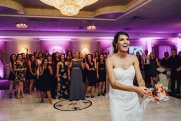 Bride throwing flowers to her bridesmaide