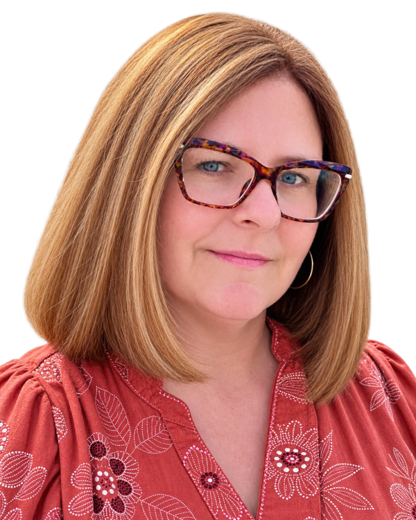 Woman with glasses smiling gently.