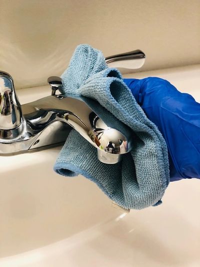 Someone cleaning the bathroom sink