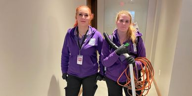 2 ready maids employee standing with their cleaning supplies