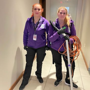 2 ready maids employee standing with their cleaning supplies