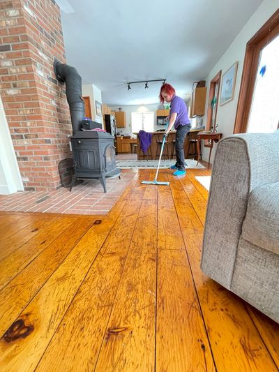 A woman mopping the wooden floor