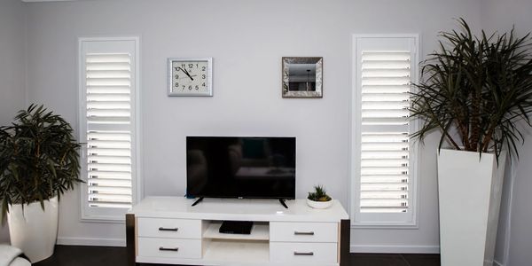 Shutter Force white plantation shutters in media room