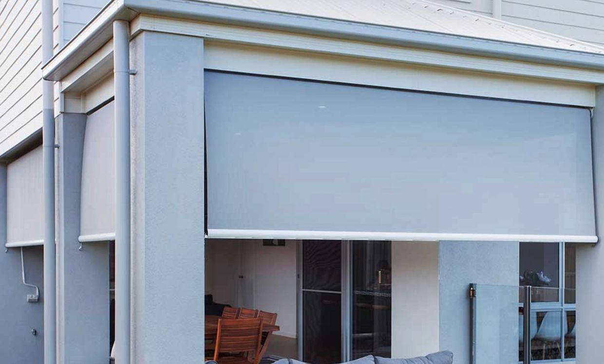 Modern outdoor patio with retractable gray sunshades.