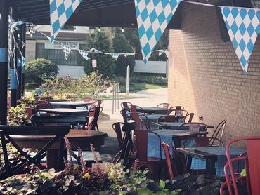 Outdoor seating area decorated with blue and white checkered flags and tablecloths.