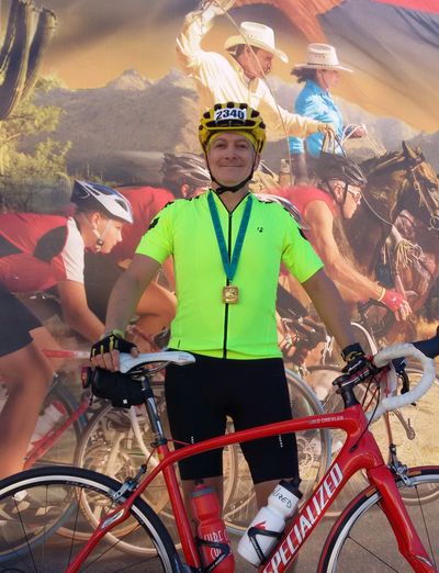 Attorney David Drexler on the podium at the Tour de Tucson accepting the Silver Metal