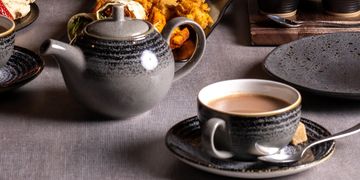A Tea Party Setting on a Grey Color Background