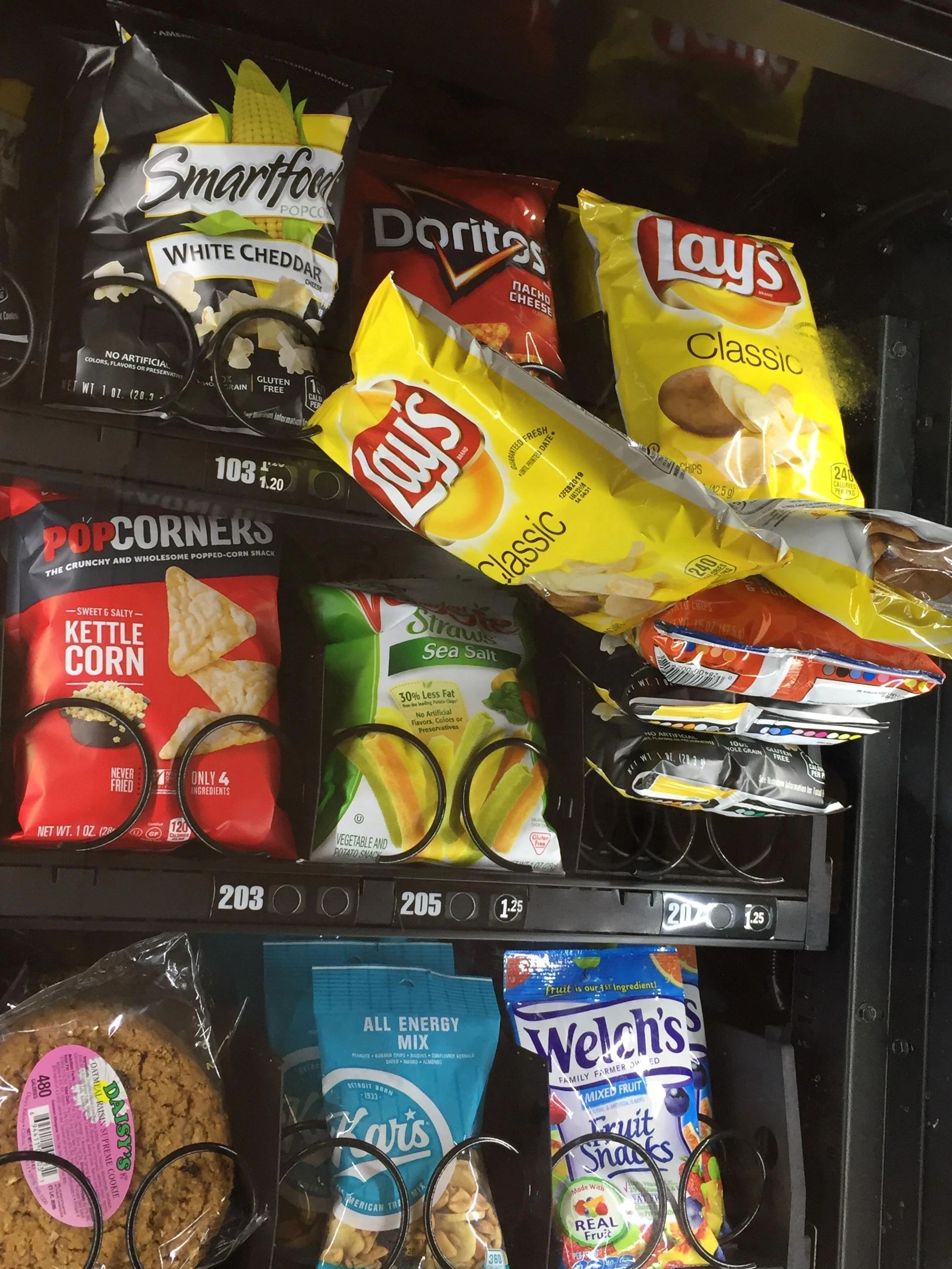 A vending machine in Kalamazoo with Snacks and Lay's chips in vending machine jammed. 