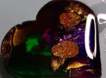 photo of resin heart in purple with gold and green accents
