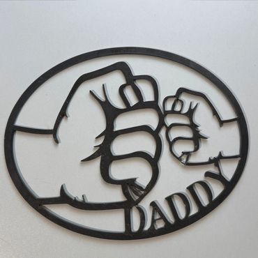 Metal art of large and small fists bumping with 'DADDY' text.