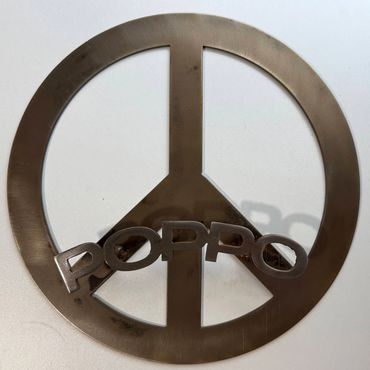 Metal peace symbol with the word 'POPPO' attached across it.
