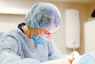 Female surgeon performing a procedure.
