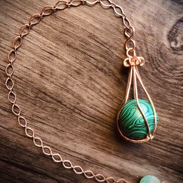 Item #103
15mm Malachite ball encaged in copper wire on an antique 6" chain.
$25 plus $3 S&H