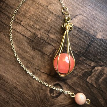 Item #102
15mm Magically translucent red aventurine ball encaged in brass wire on a 6" brass chain a