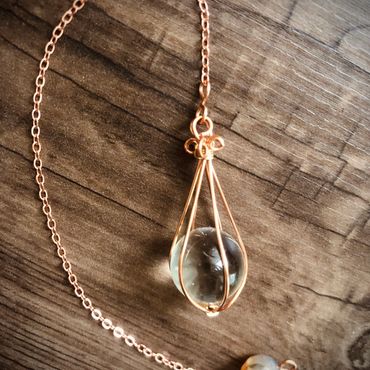 Item #100
15mm 'Crystal' ball encaged in copper & brass wire on 6" chain.
$20 plus $3 S&H