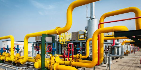 Industrial gas pipeline system with yellow pipes and valves.