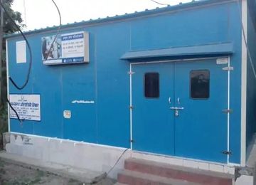 Blue portable building with locked double doors and signage in Hindi.