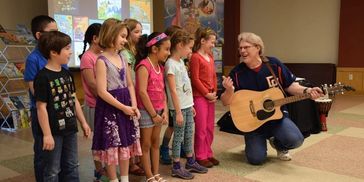 Author Daryl Cobb performs a "It's All In The Words" at his author visits program "Music & Storytime