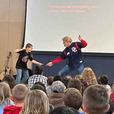 Author Daryl Cobb performs with student during a live action reading of "Do Pirates Go To School?"
