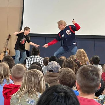Author Daryl Cobb performs with student during a live action reading of "Do Pirates Go To School?"