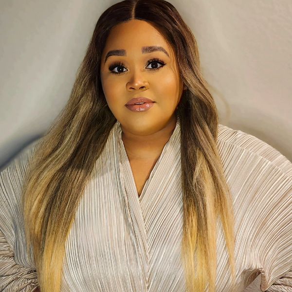 A photo of the owner partly smiling.