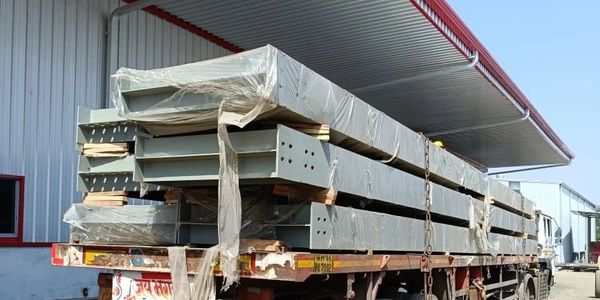 Metal beams loaded on a truck for transport.